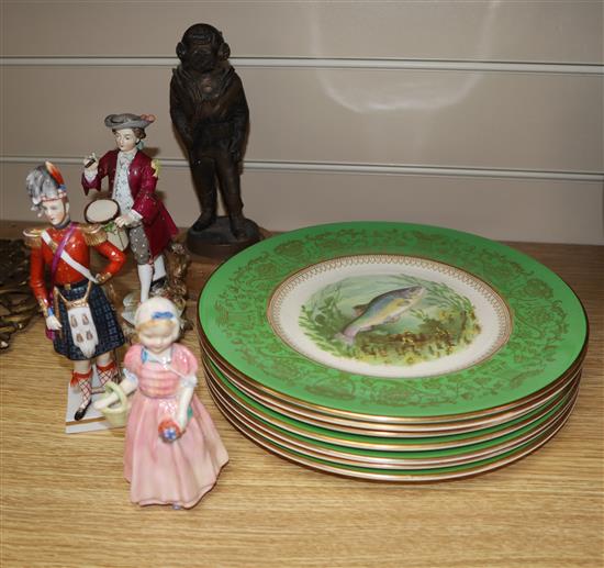 Three porcelain figures and eight plates, and a resin figure of a diver, etc.